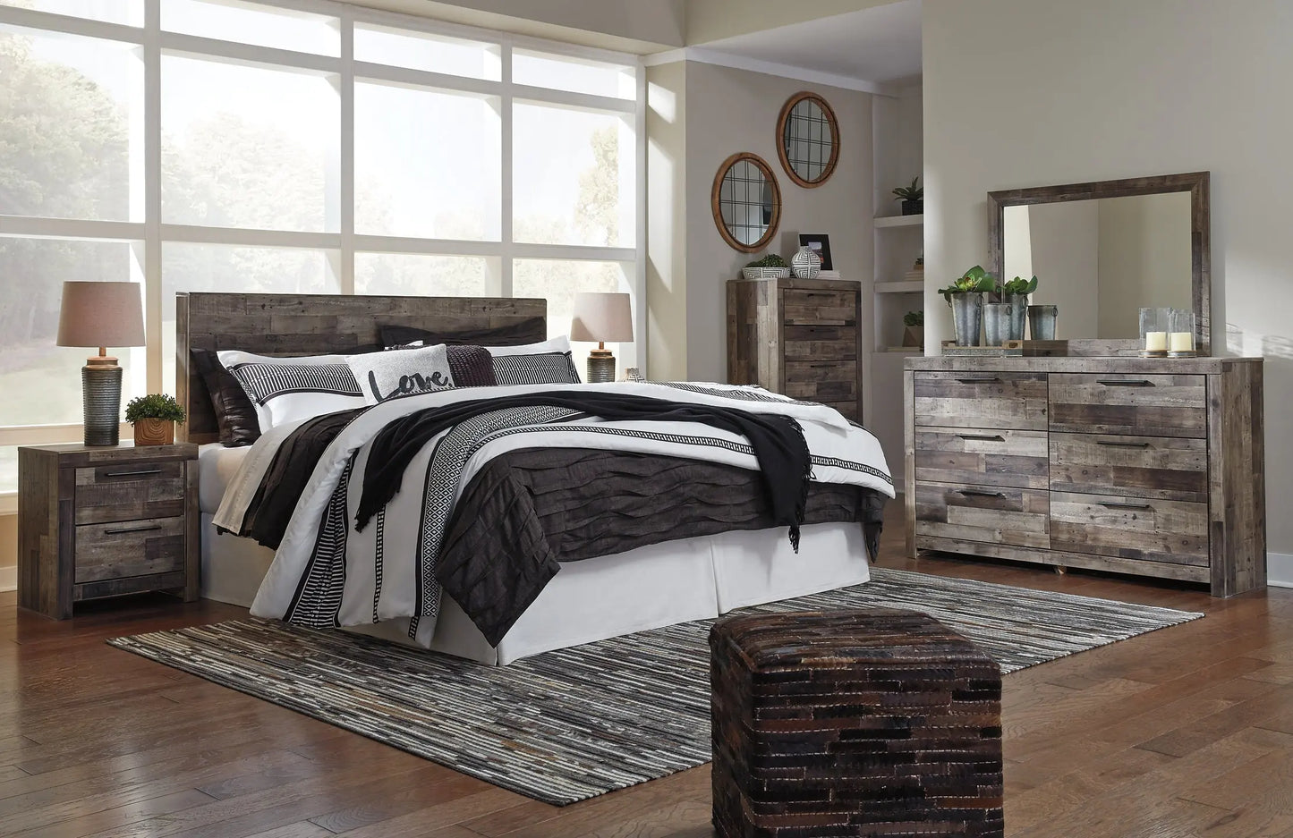 Derekson King Panel Headboard with Mirrored Dresser, Chest and Nightstand - Premier Furniture & Mattress