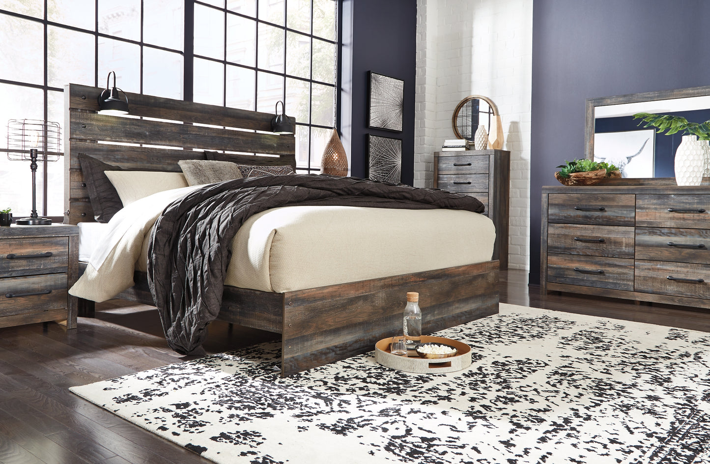 Drystan King Panel Bed with Mirrored Dresser, Chest and Nightstand - Premier Furniture & Mattress