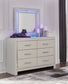 Zyniden King Upholstered Panel Bed with Mirrored Dresser