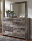 Derekson King Panel Bed with Mirrored Dresser, Chest and Nightstand - Premier Furniture & Mattress