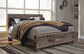 Derekson King Panel Bed with Mirrored Dresser, Chest and Nightstand - Premier Furniture & Mattress
