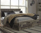 Derekson King Panel Bed with 6 Storage Drawers with Mirrored Dresser, Chest and Nightstand - Premier Furniture & Mattress