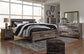 Derekson King Panel Bed with Mirrored Dresser, Chest and Nightstand - Premier Furniture & Mattress