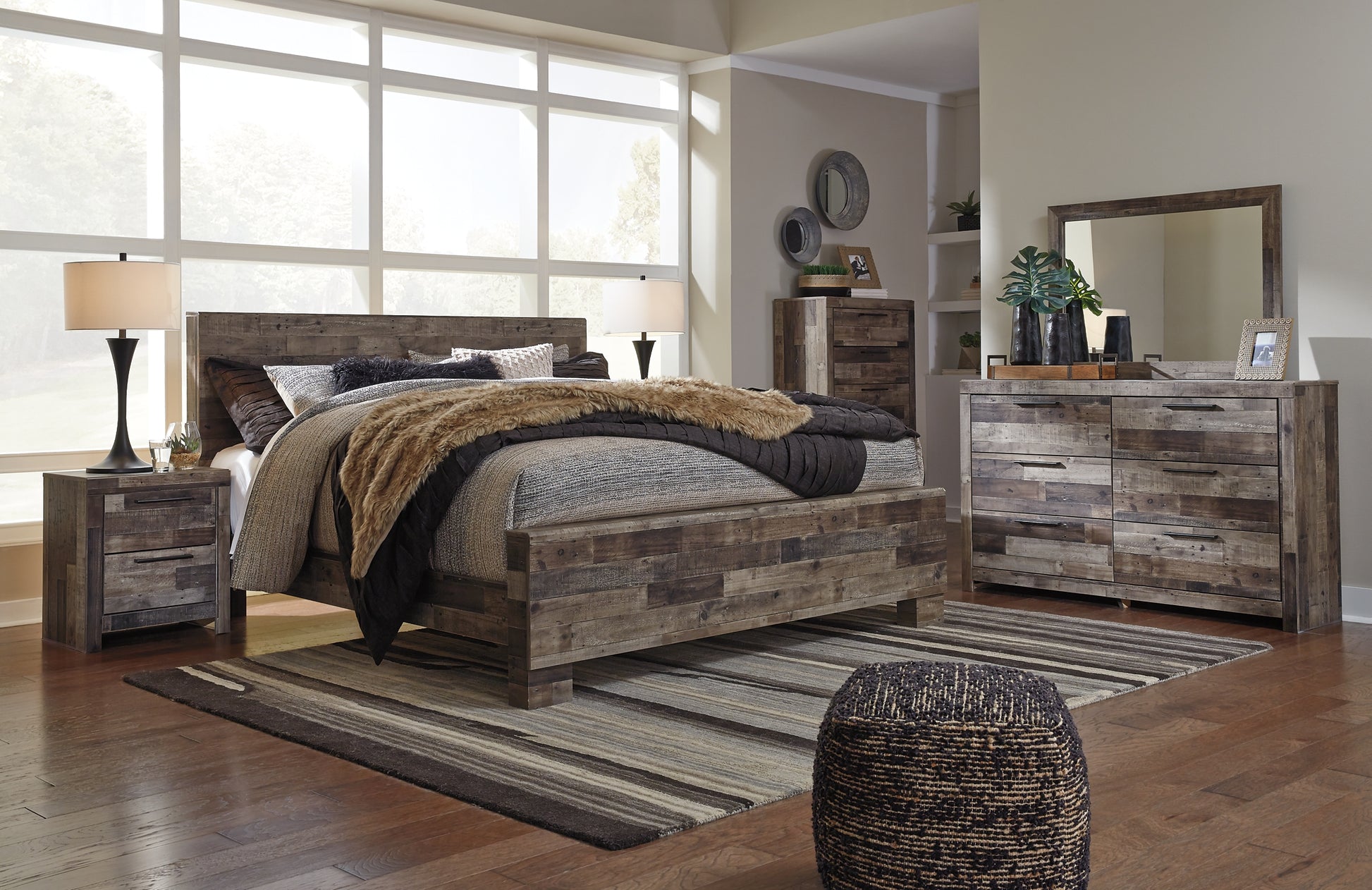 Derekson King Panel Bed with Mirrored Dresser, Chest and Nightstand - Premier Furniture & Mattress