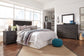Brinxton King/California King Panel Headboard with Mirrored Dresser, Chest and Nightstand - Premier Furniture & Mattress